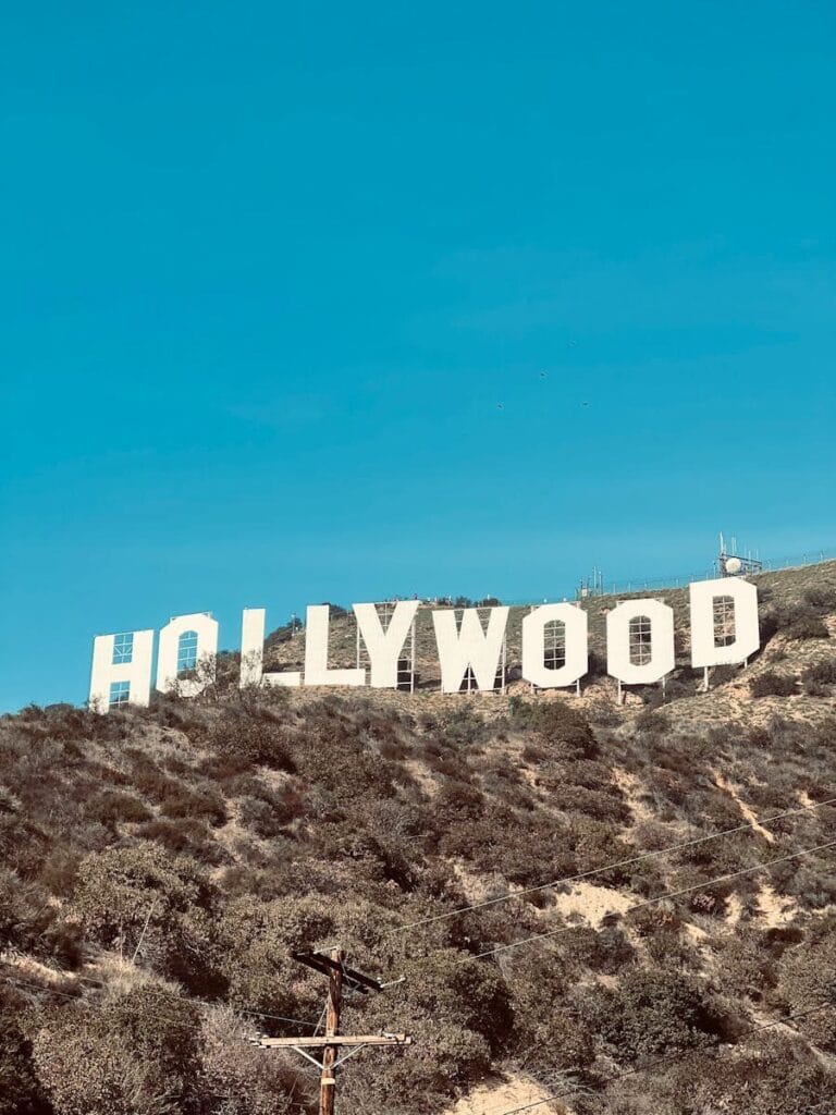 Famous Hollywood Sign under clear blue skies in Los Angeles, CA.